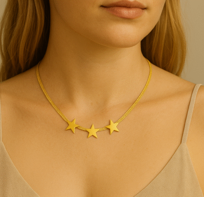 Femme portant un collier ras du cou doré à maille plate avec trois étoiles
